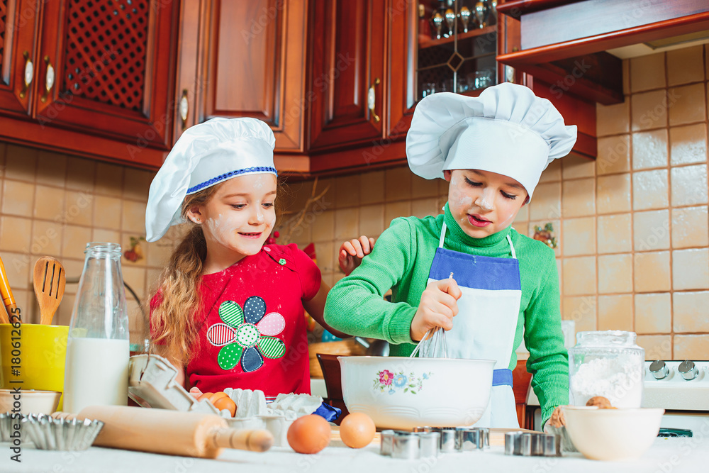 happy family funny kids are preparing the dough, bake cookies in the kitchen