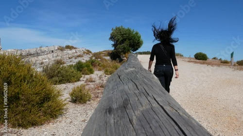 Girl walking in a desert  with an amazing blue sky