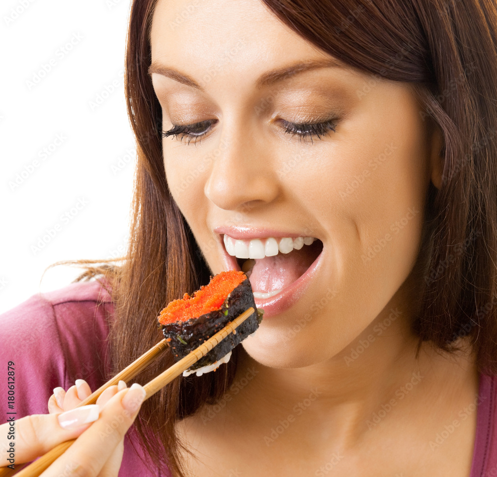 Beautiful woman eating sushi roll, over white Beautiful woman eating sushi roll, over white