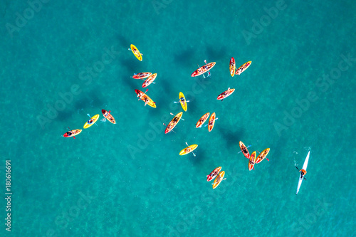 Large group of yellow Kayaks at calm water - Top down aerial view