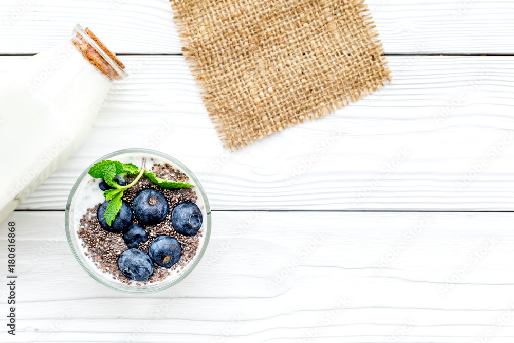Eat chia seeds for breakfast with yogurt, blueberry and mint. White background top view copyspace Eat chia seeds for breakfast with yogurt, blueberry and mint. White background top view copyspace