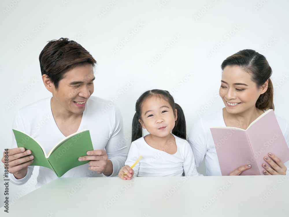 Attractive Asian Family Holding Book Together. Happy Family Concept. Attractive Asian Family Holding Book Together. Happy Family Concept.
