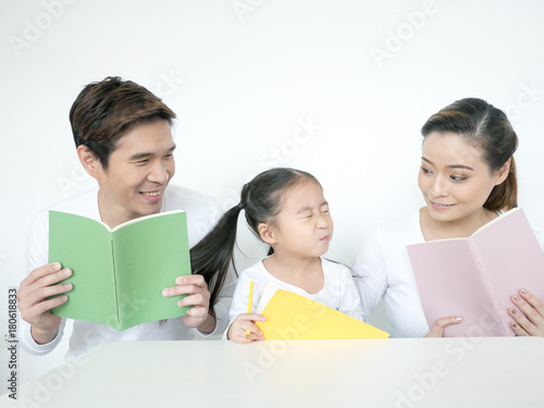 Attractive Asian Family Holding Book Together. Happy Family Concept. photo