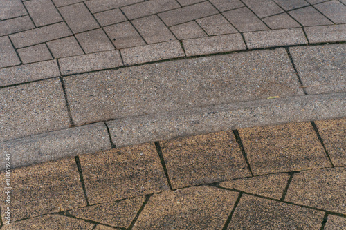 Grey brick stone street road. Light sidewalk, pavement texture. Road