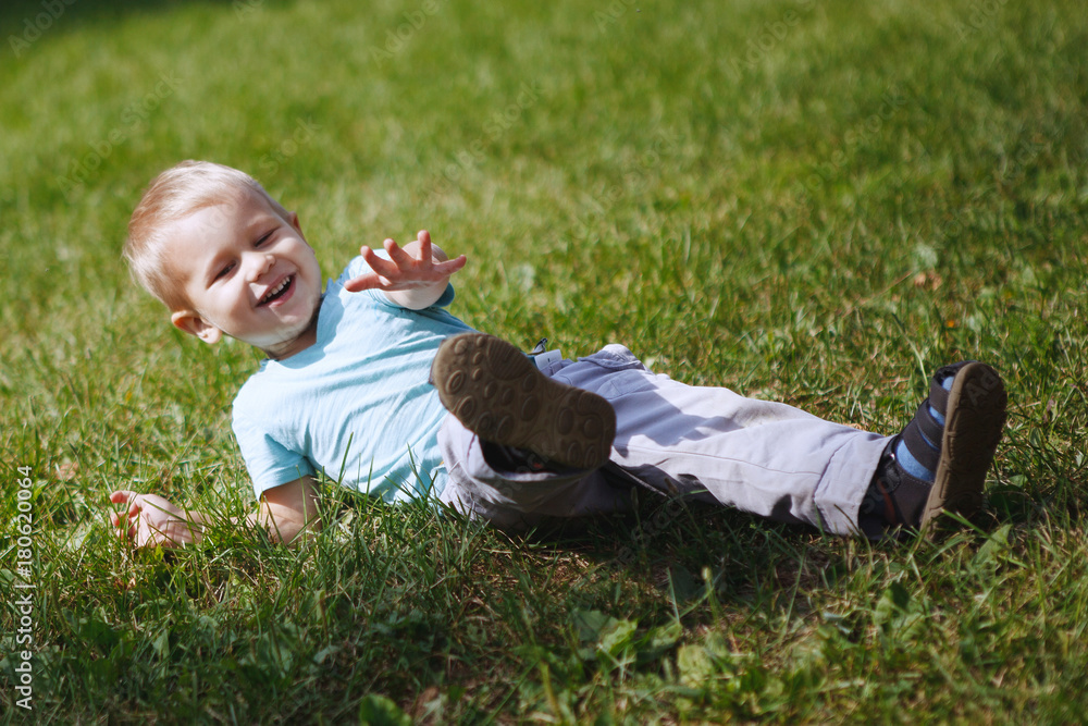 Little boy having fun playing in the Park on the grass Little boy having fun playing in the Park on the grass