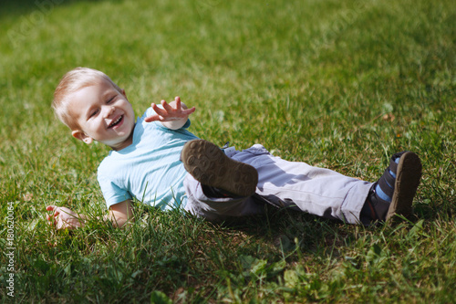 Little boy having fun playing in the Park on the grass