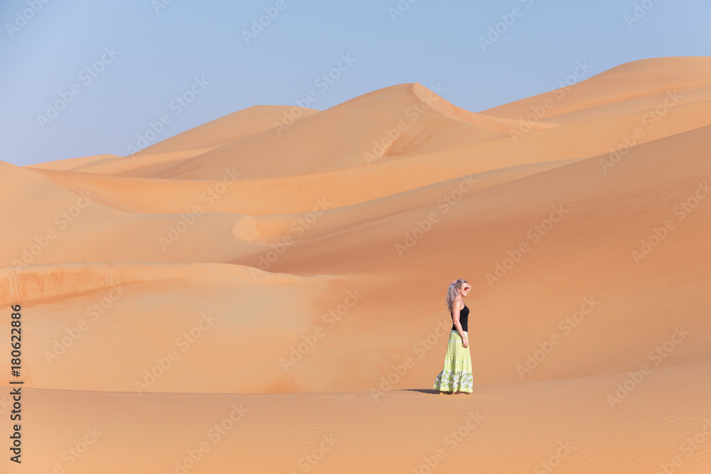 Young woman walking around desert.