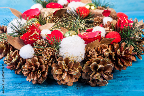 Christmas wreath on blue wooden background in studio photo