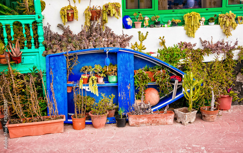 Pretty house decoration with old fishermen boat and caktuses in Lanzarote , Canary islands