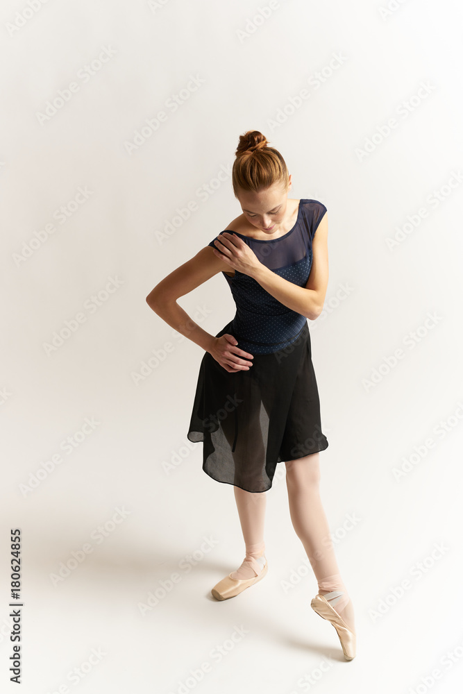 ballerina with an elongated leg and a covered shoulder ballerina with an elongated leg and a covered shoulder