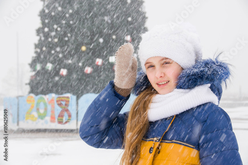 Teenager girl by the big new year tree photo