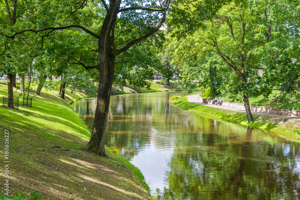 beautiful city park with river in summer day beautiful city park with river in summer day