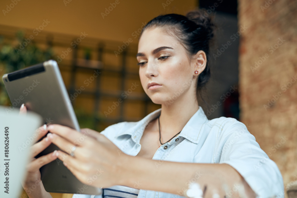 the girl is holding a tablet the girl is holding a tablet