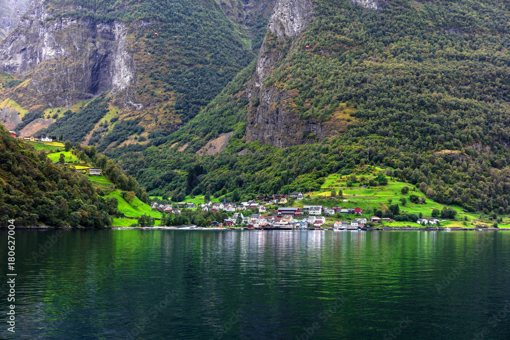 Fototapeta premium Reflection of small town in norwegian fiord, Norway