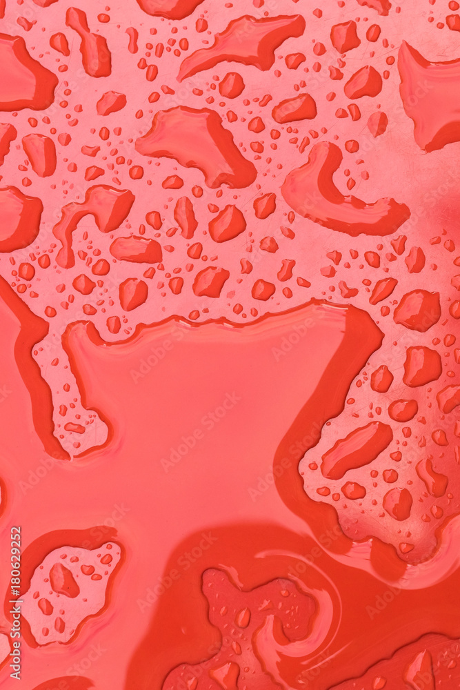Obraz premium Water drops on red background