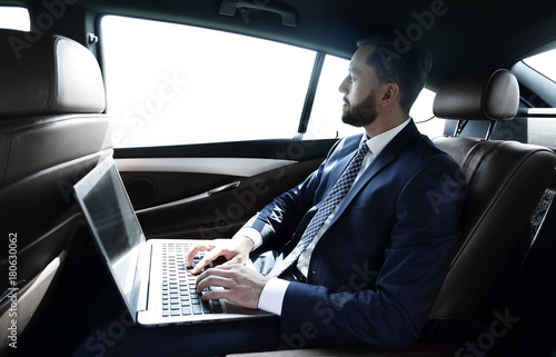 Businessman working with laptop sitting in car © ASDF