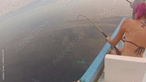 Young fisher woman on a boat fishing a big fish Dorado of 15 lb in Baja de los Muertos, California Sur, Mexico, America. Summer leisure and sport. Mahi Mahi fishing in Mexico. photo