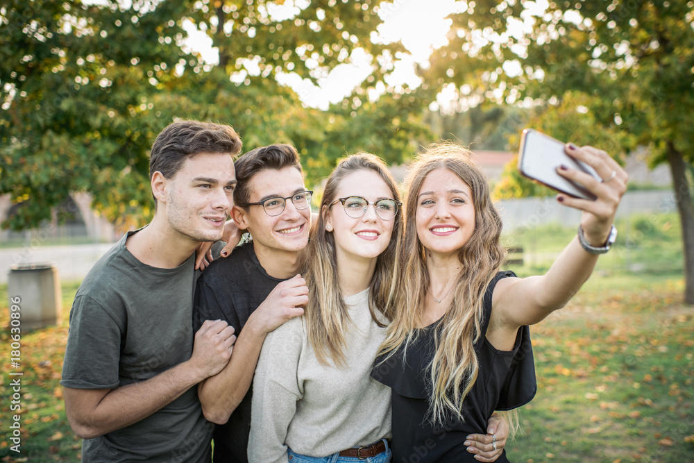 Obraz premium Cityscapes and Skylines - Group of friends taking a self portrait in the park.