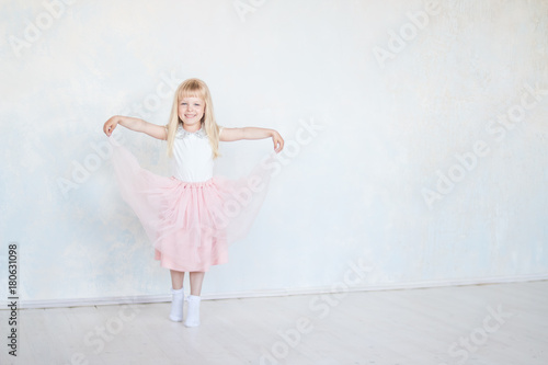 small happy girl dancer isolated.Cute little dancing, jumping,running child.  Children dance. Kids performing. Young gifted dancer in a class.Baby girl is studying ballet, modern dance.copy space