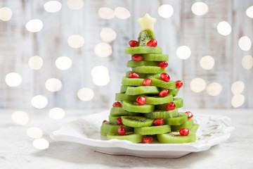 Healthy dessert idea for kids party - funny edible kiwi pomegranate Christmas tree