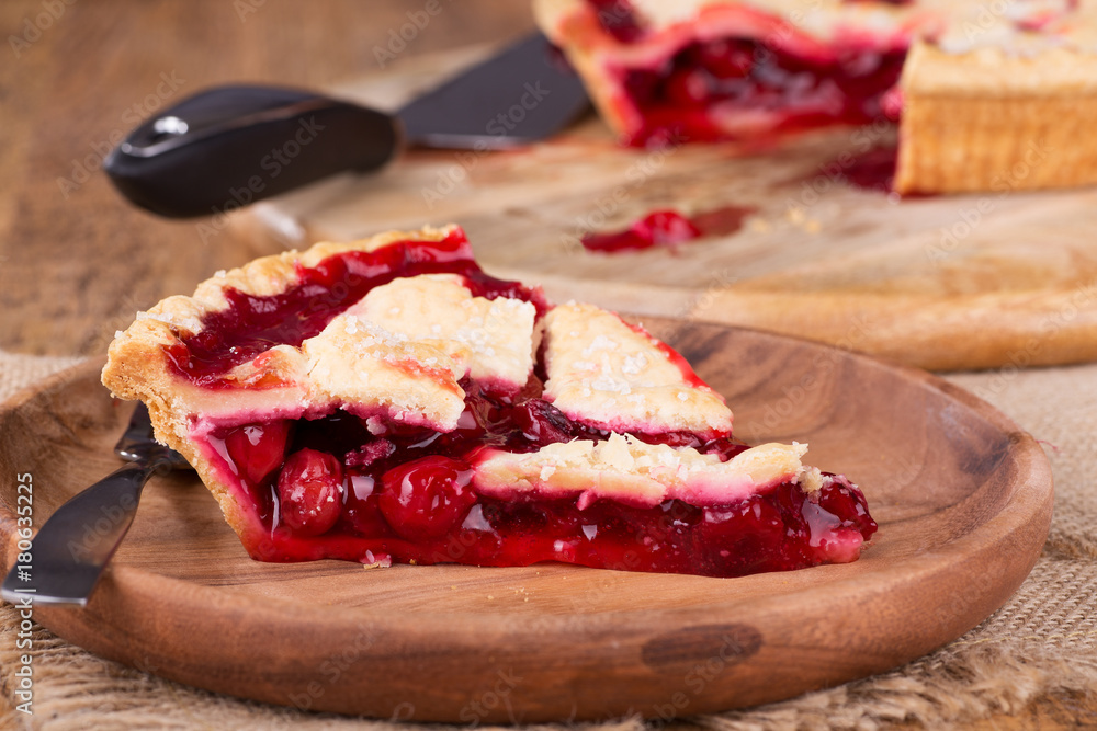 Slice of Cherry Pie on a Wooden Plate