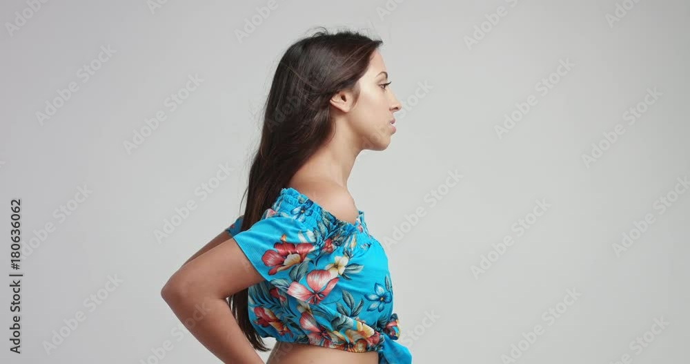 Pretty young ethnic brunette woman in light blue floral peasant top dancing and smiling isolated on white Pretty young ethnic brunette woman in light blue floral peasant top dancing and smiling isolated on white