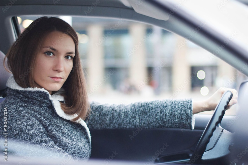 Young woman driving her car in the city Young woman driving her car in the city