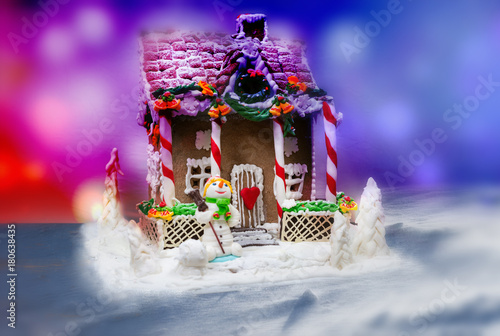 Christmas gingerbread house decoration on background of defocused lights © kolotype