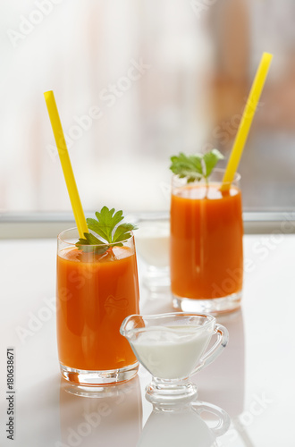 Two glasses of carrot juice and cream
