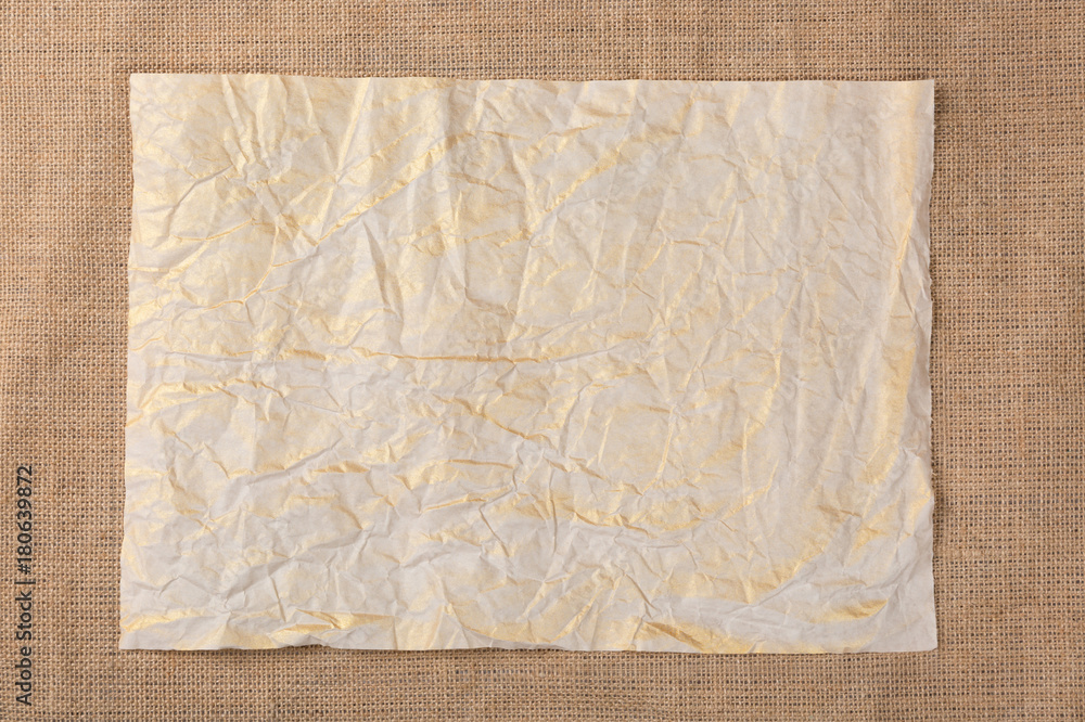 Old crumpled paper sheet on canvas sackcloth background. Top view. Stock  Photo | Adobe Stock