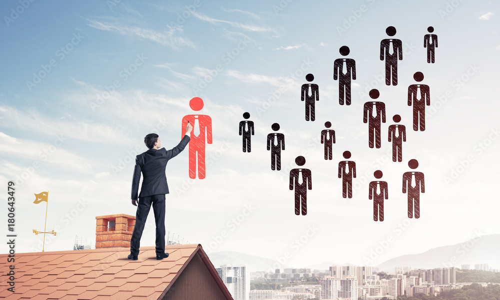 Businessman standing with back on house brick roof and drawing. Businessman standing with back on house brick roof and drawing.