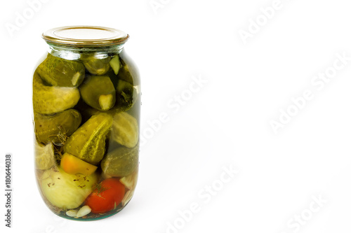 green glass jar with pickled cucumbers isolated on white backgrou