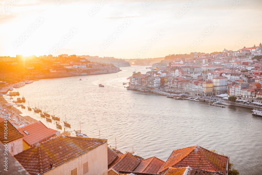 Aerial landscape view on the Douro river and old town of Porto during the sunset in Portugal