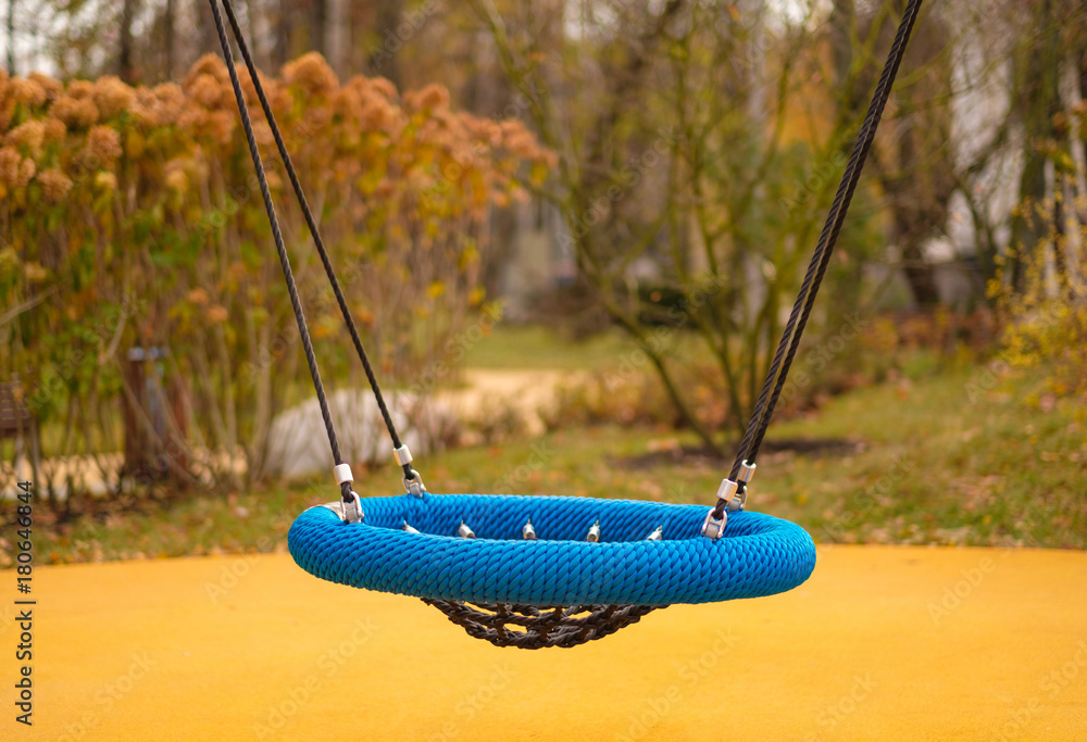 Modern equipped kids playground in sunny day. Net round swing Stock Photo