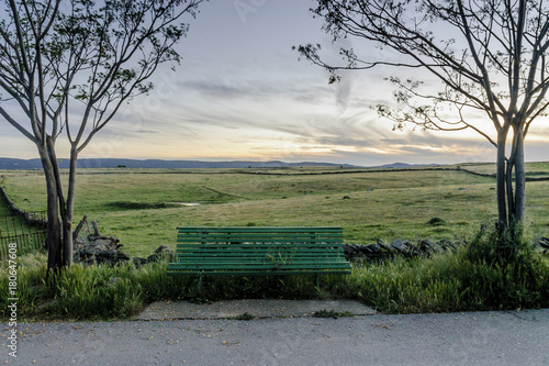 wooden bench to the evening in the pastures of the range of Saint Peter in Caceres, Spain. photo