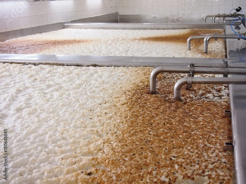 Fermenting of a beer in an open fermenters in a brewery. photo