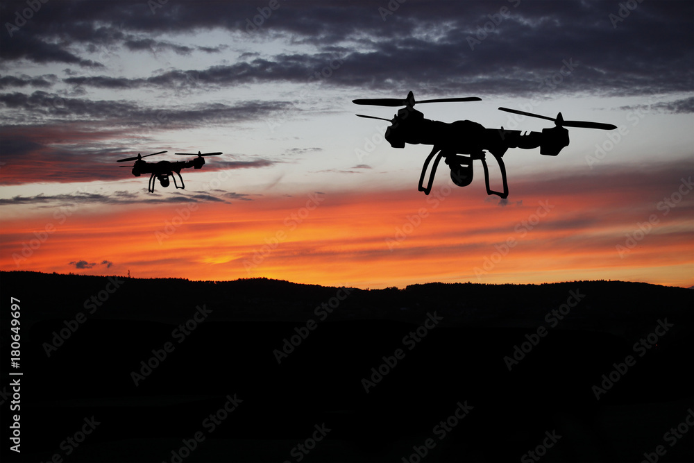 Innovation concept. Silhouette of drone flying on sunset. Heavy lift drone photographing Innovation concept. Silhouette of drone flying on sunset. Heavy lift drone photographing