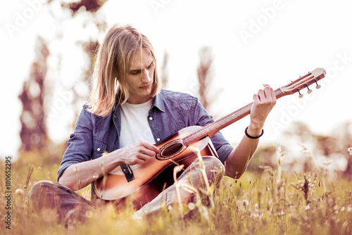 Man with guitar in nature.