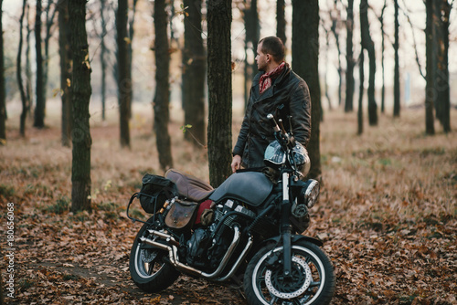 Man and old custom cafe-racer Motorcycle on forest  © tol_u4f