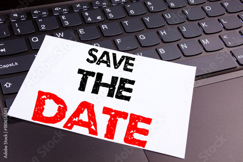 Save The Date writing text made in the office close-up on laptop computer keyboard. Business concept for Special Day and Greeting on the black background with copy space photo