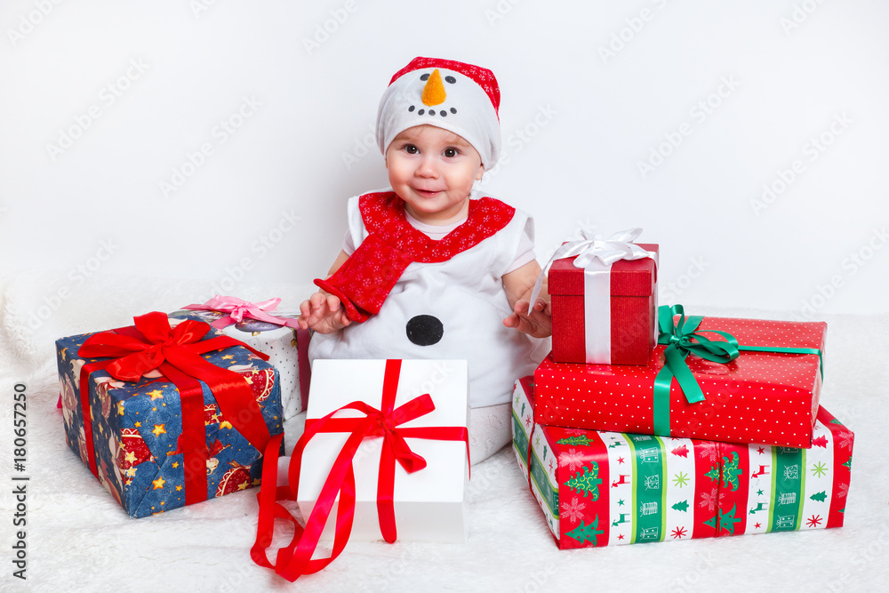 happy baby in snowman costume with christmas present gift boxs happy baby in snowman costume with christmas present gift boxs