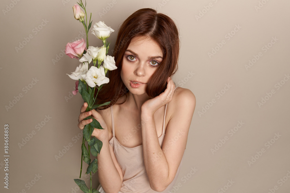 woman with a bouquet of flowers on a gray background woman with a bouquet of flowers on a gray background