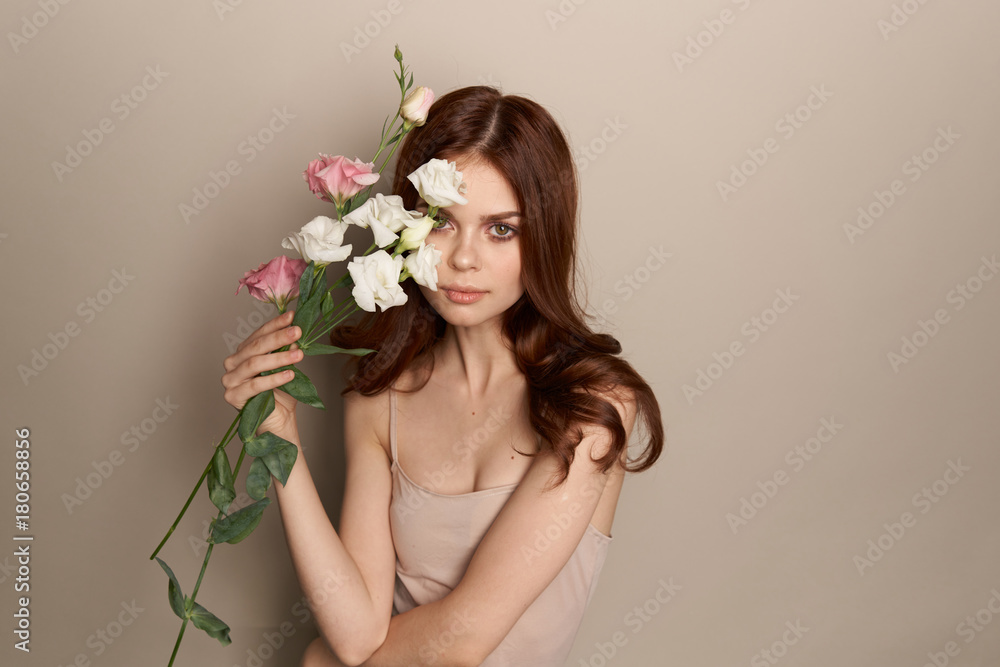 beautiful woman with a bouquet of flowers covers her face beautiful woman with a bouquet of flowers covers her face