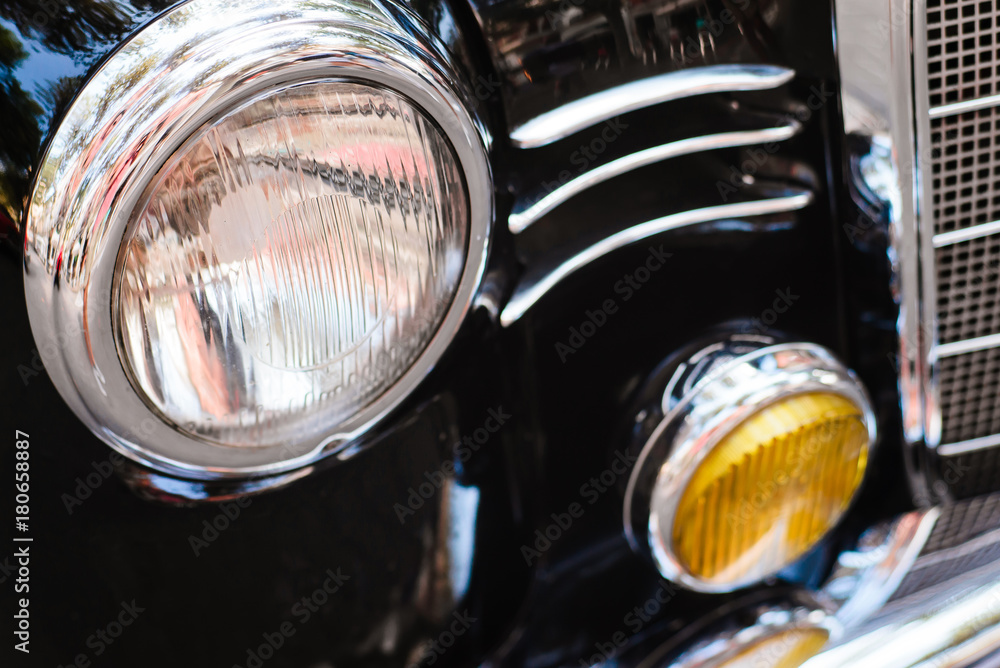 Close-up of front headlight of black vintage car.