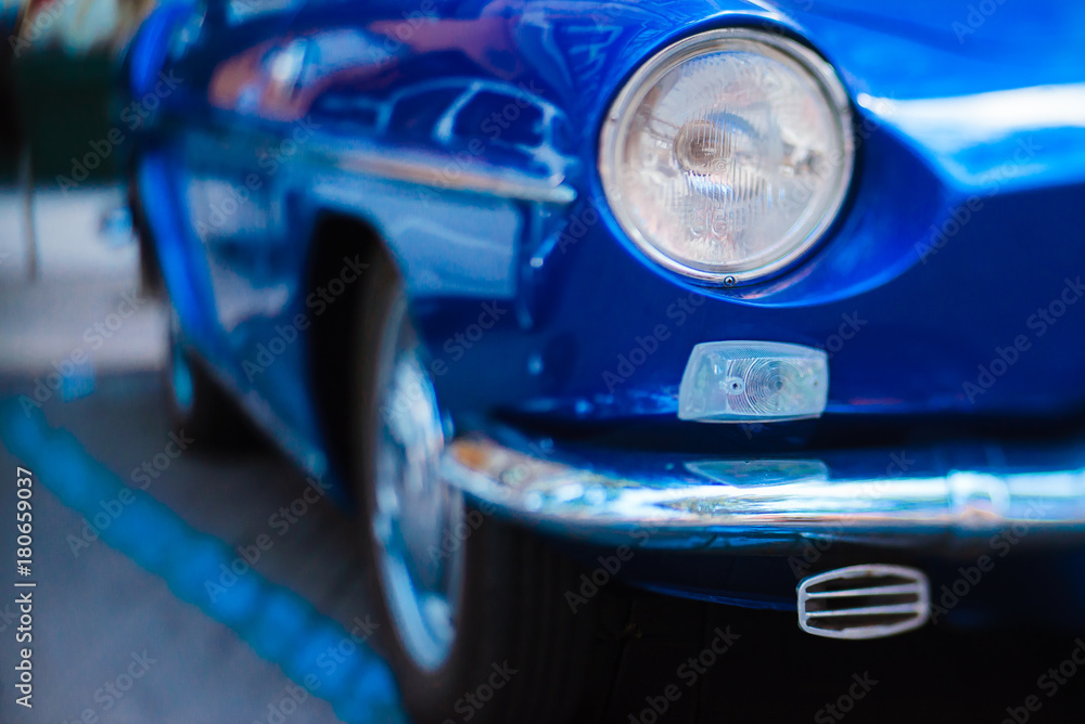 Close-up of front headlight of blue vintage car