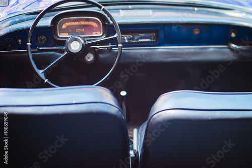 Black leather interior of a vintage car © bodiaphoto