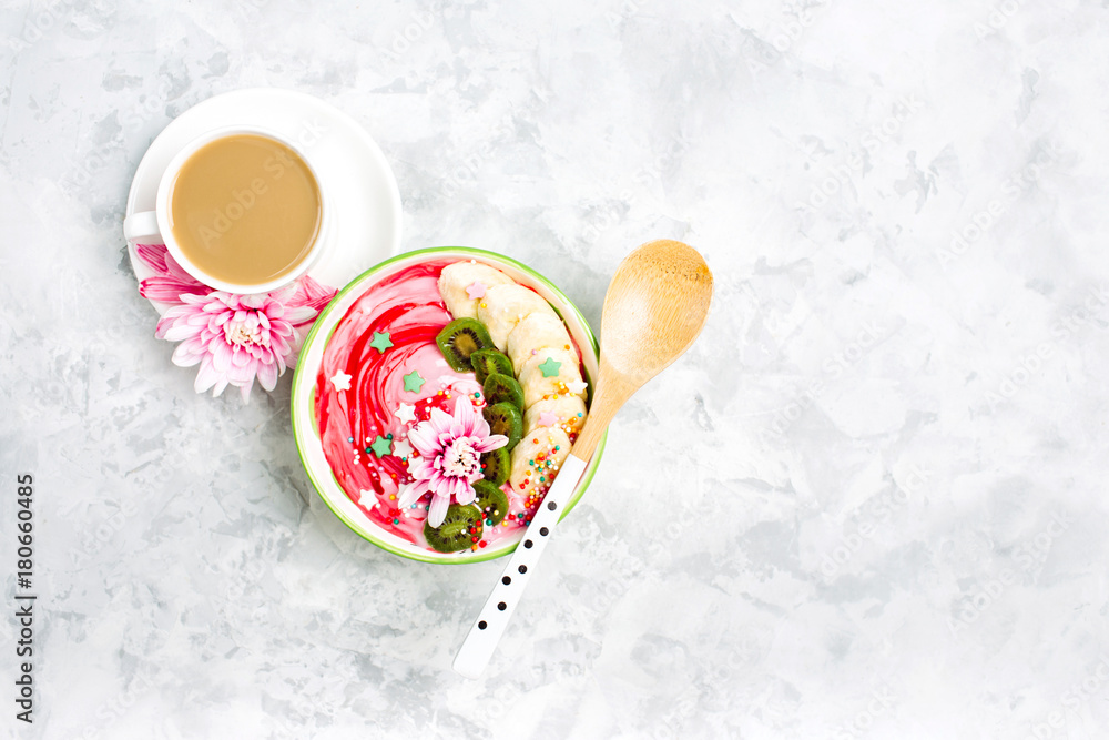 Berry smoothie with kiwi and banana in a bow and cup of coffee with flowers. Cute breakfast Berry smoothie with kiwi and banana in a bow and cup of coffee with flowers. Cute breakfast