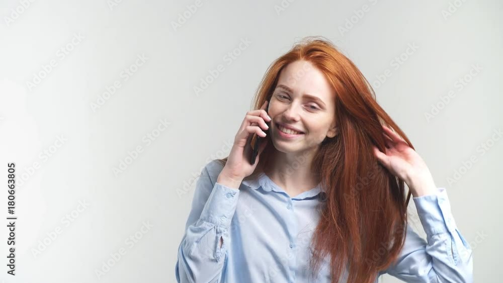 Young Attractive Redhead Girl Talking By Phone With Friend And Smiling. Young Attractive Redhead Girl Talking By Phone With Friend And Smiling.