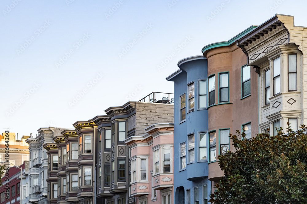 Sunset light shines on a row of colorful buildings on Filbert Street in San Francisco, California