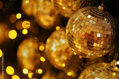 close up mirror ball or Christmas ball to decorative for Christmas festival with bokeh golden tonebackground. Have some space for write wording